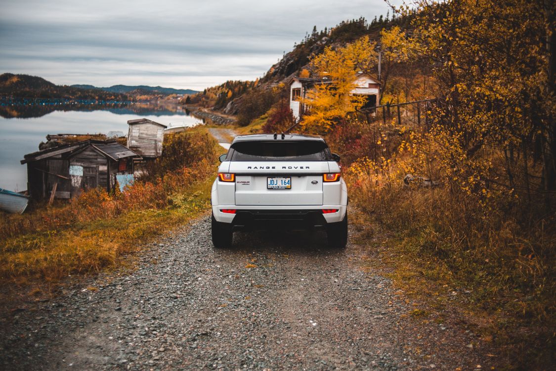White Nissan Suv on Gray Dirt Road During Daytime. Wallpaper in 5232x3488 Resolution