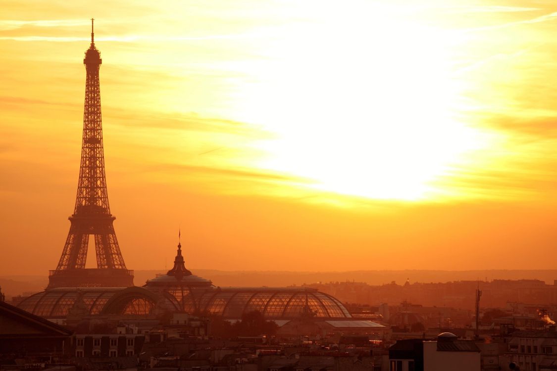 city buildings during sunset with tower clock