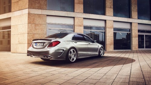 Image silver mercedes benz coupe parked beside brown brick building