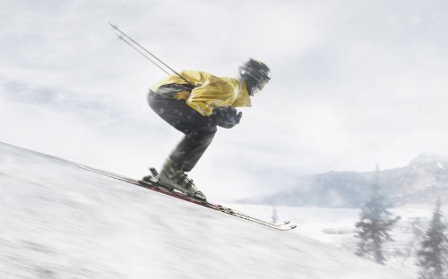 Image man in yellow jacket and blue denim jeans riding ski blades on snow covered ground during