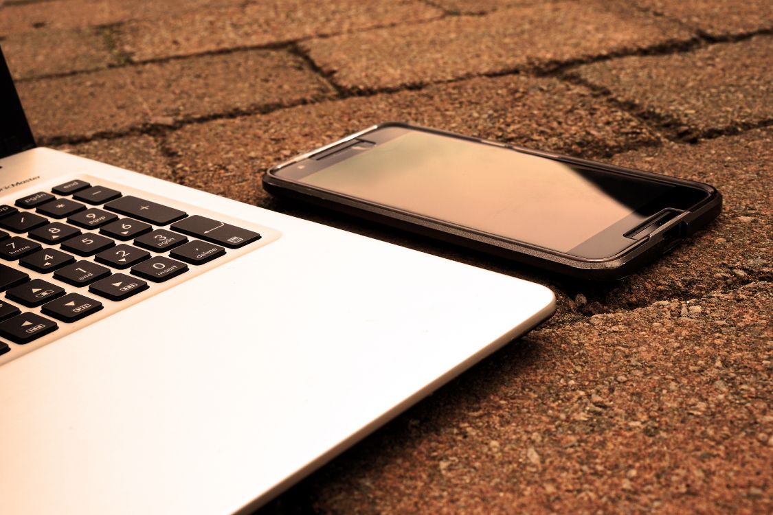 black android smartphone on macbook pro