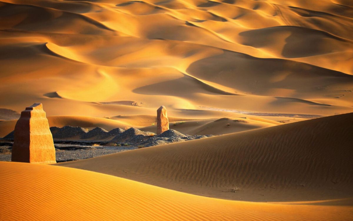 person walking on desert during daytime