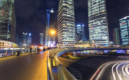 Image cars on road near high rise buildings during night time