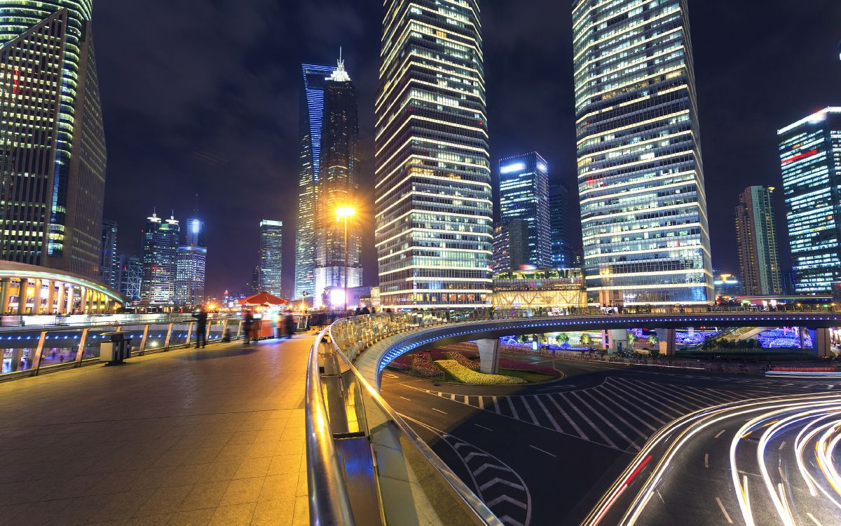 cars on road near high rise buildings during night time