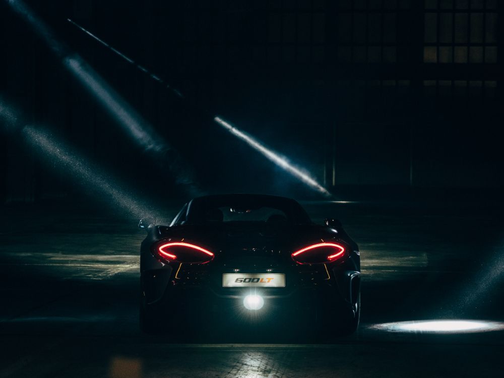 red ferrari sports car on road during nighttime