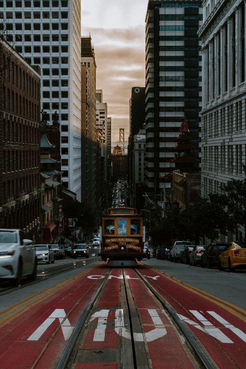 Cars on Road Between High Rise Buildings During Daytime. Wallpaper in 1847x2767 Resolution