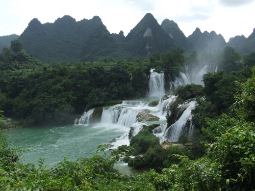 Image waterfalls near green trees and mountain during daytime