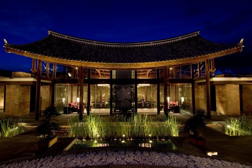 Image brown wooden building with lights turned on during night time