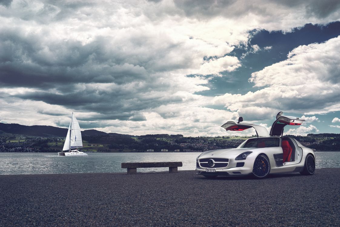 white porsche 911 on beach during daytime