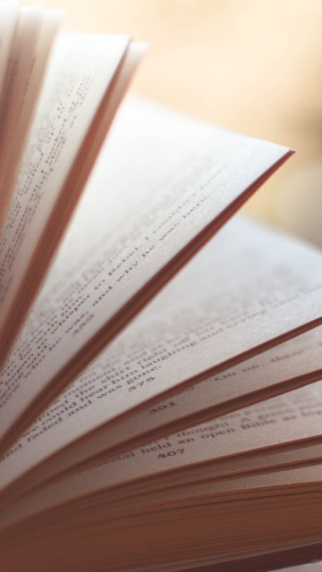 Image white open book on brown wooden table