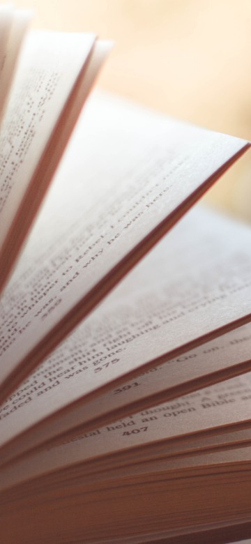 Image white open book on brown wooden table