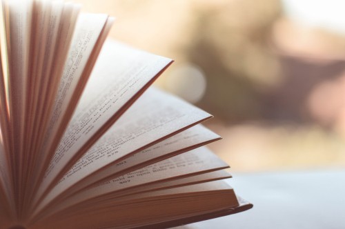 Image white open book on brown wooden table