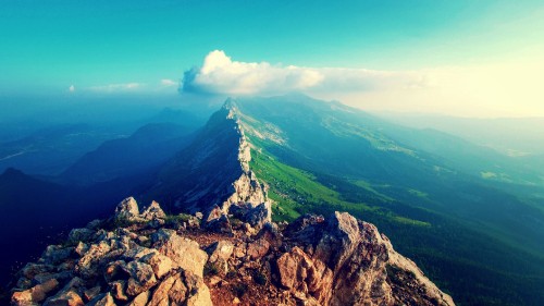 Image green and gray mountain under blue sky during daytime