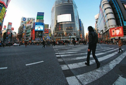 Image man in black jacket walking on pedestrian lane during daytime