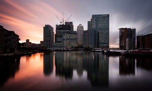 Image city skyline across body of water during daytime