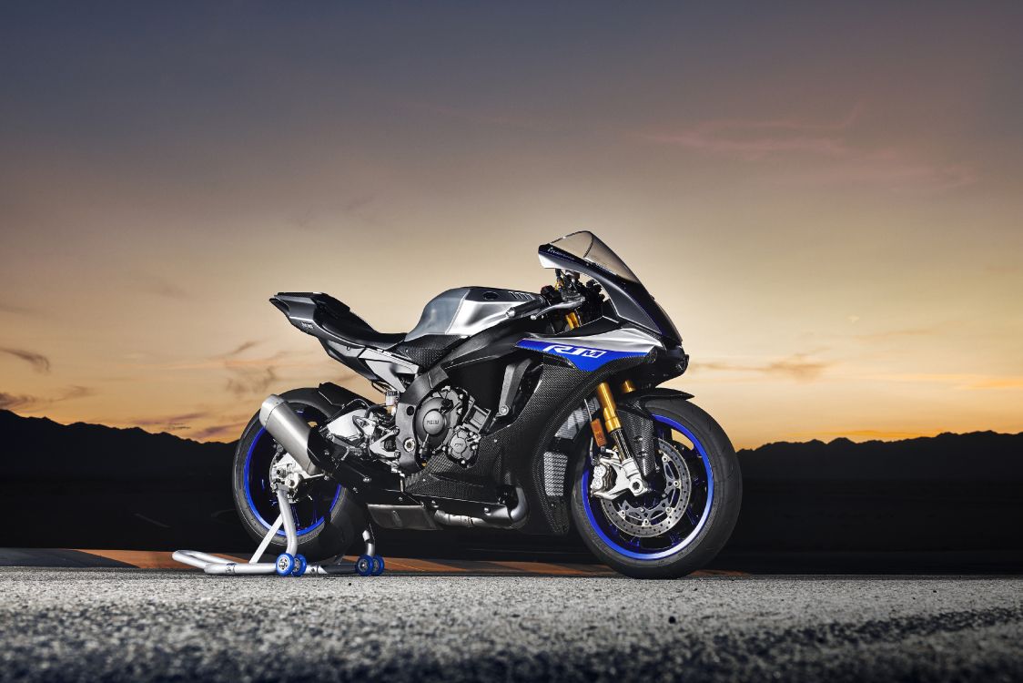 black sports bike on gray asphalt road during daytime