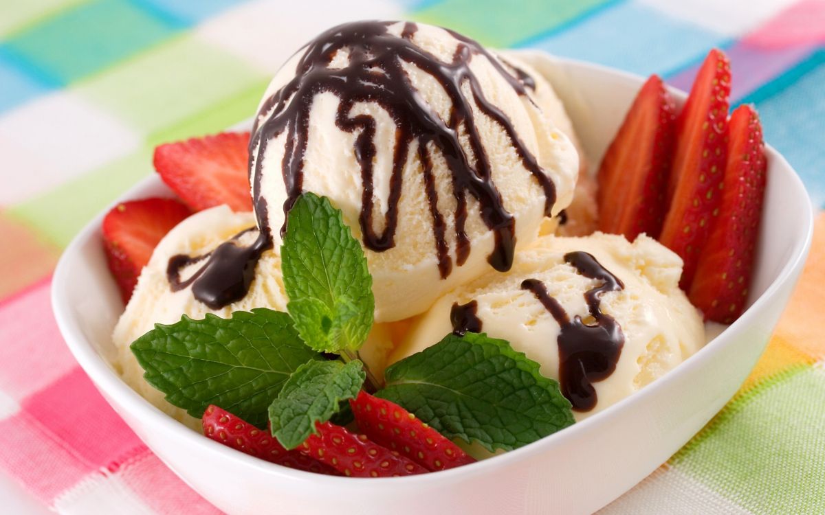 ice cream with strawberry on white ceramic bowl