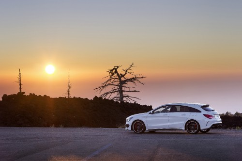 Image white sedan on snow covered road during sunset