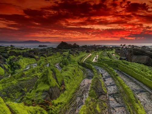 Image green mountain under orange sky