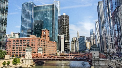 Image brown concrete building near bridge during daytime