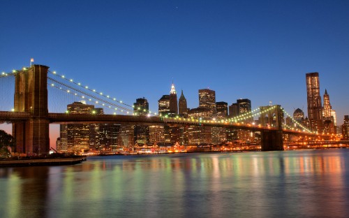 Image lighted bridge over water during night time