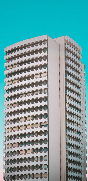 Image white concrete building under blue sky during daytime