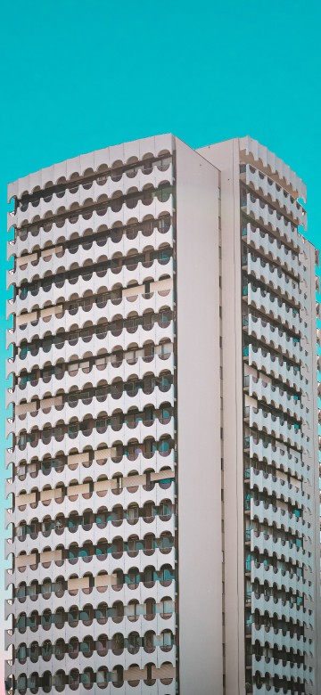Image white concrete building under blue sky during daytime