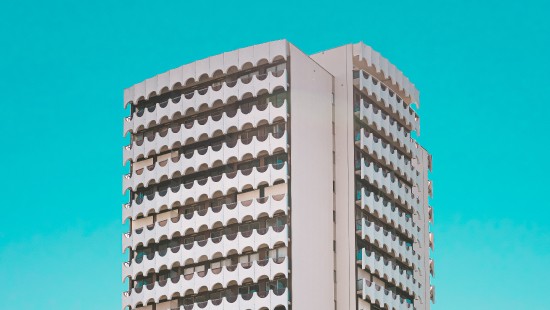 Image white concrete building under blue sky during daytime