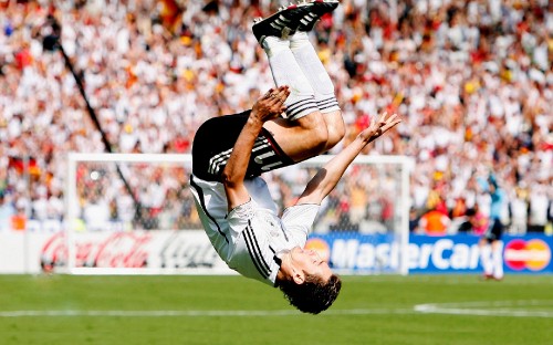 Image man in black shirt and white pants doing push up on field