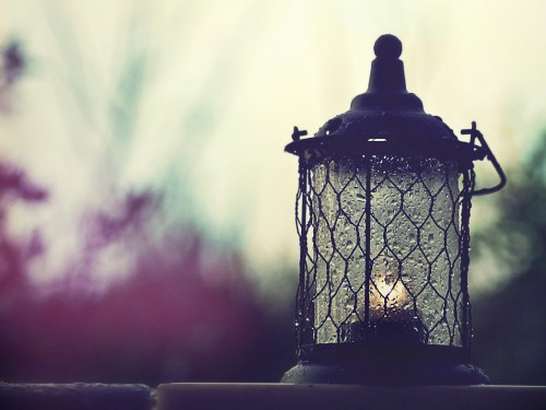 Image black metal candle lantern on table