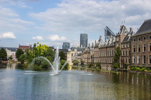 Image water fountain in the middle of city buildings during daytime