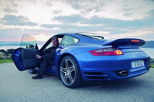 Image blue porsche 911 on gray asphalt road during daytime