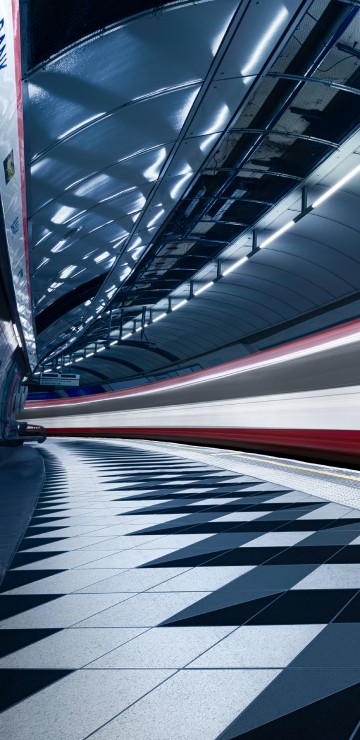 Image red and white train in a tunnel