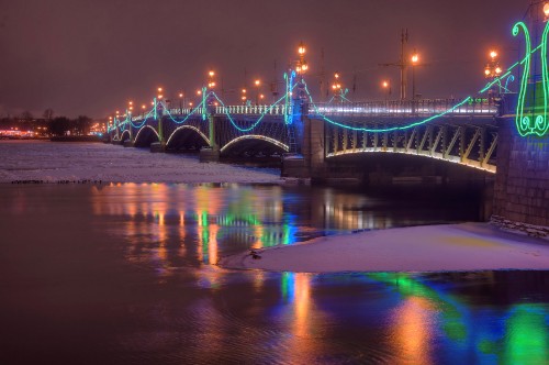 Image blue bridge over water during night time