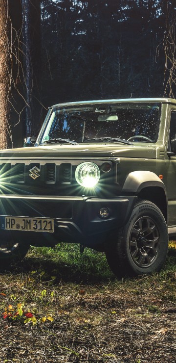Image black mercedes benz g class suv parked beside brown tree during daytime