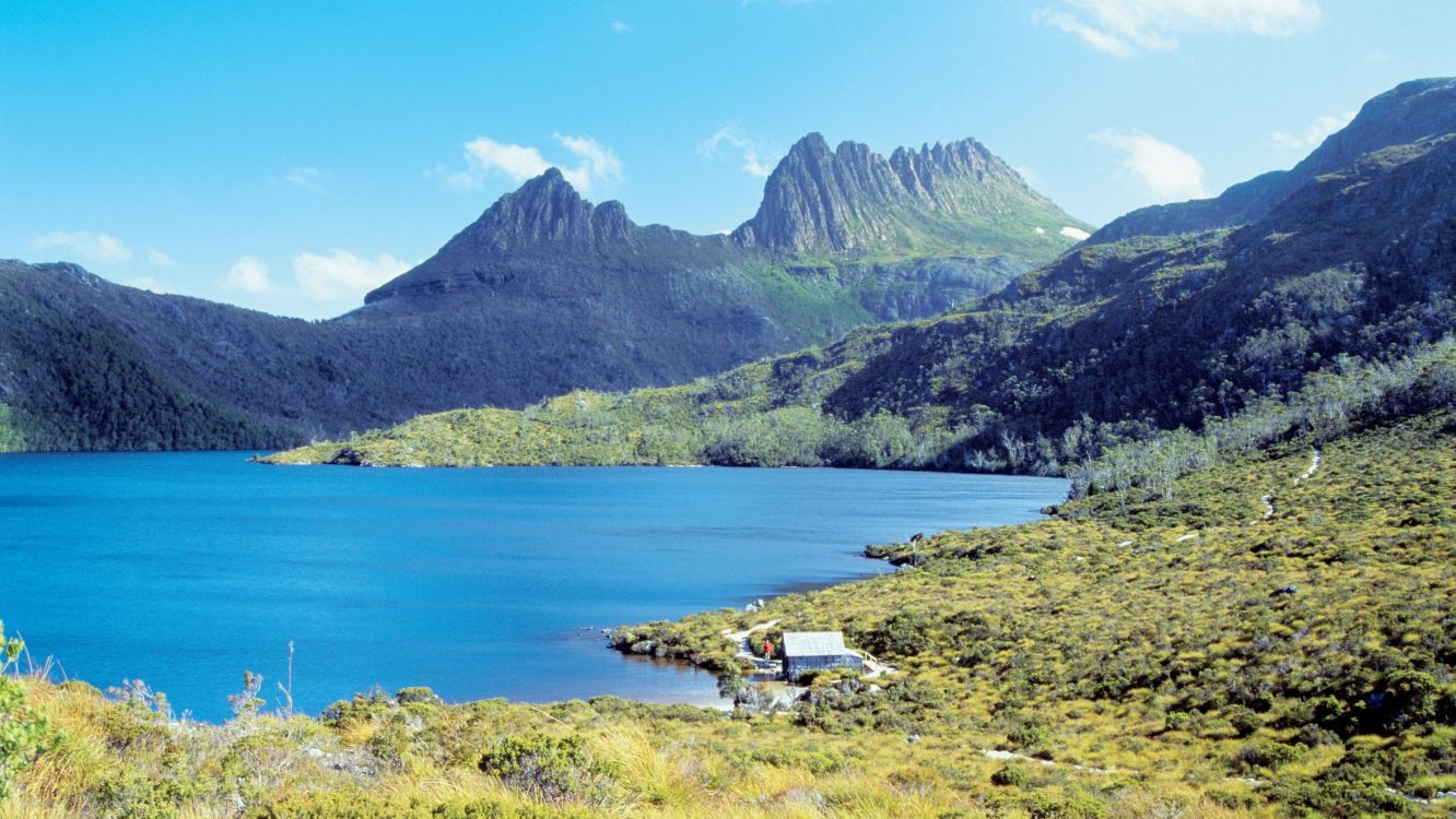 green mountains near body of water during daytime