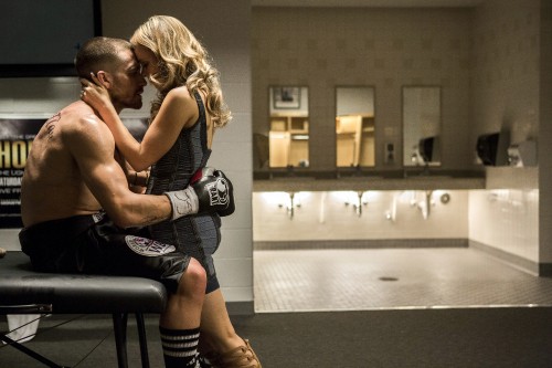 Image woman in black tank top and blue denim shorts kissing man in black shorts