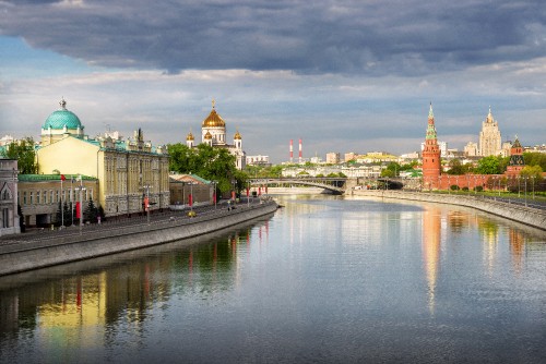 Image body of water near buildings under cloudy sky during daytime