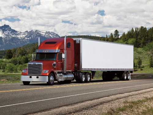 Image red and white freight truck on road during daytime