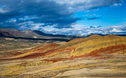 Image brown and gray mountains under blue sky during daytime