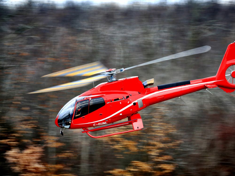 red and white helicopter on the sky