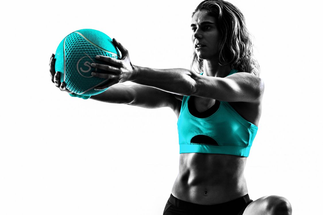 woman in red sports bra holding basketball