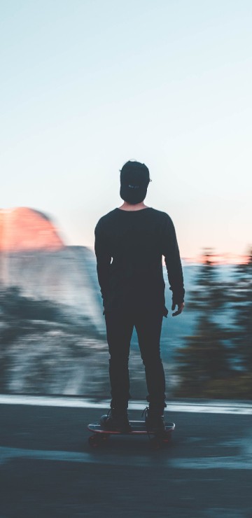 Image man in black jacket standing on road during daytime