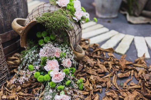 Image pink and white flowers on brown wooden round pot