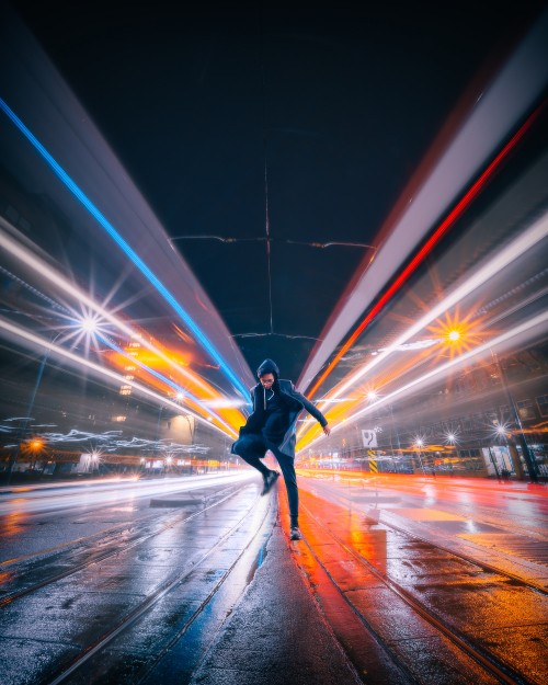 Image man in black jacket and black pants walking on street during night time