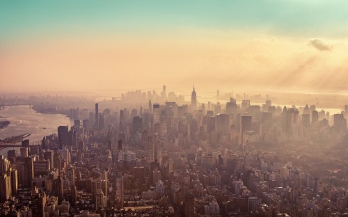 Image aerial view of city buildings during sunset