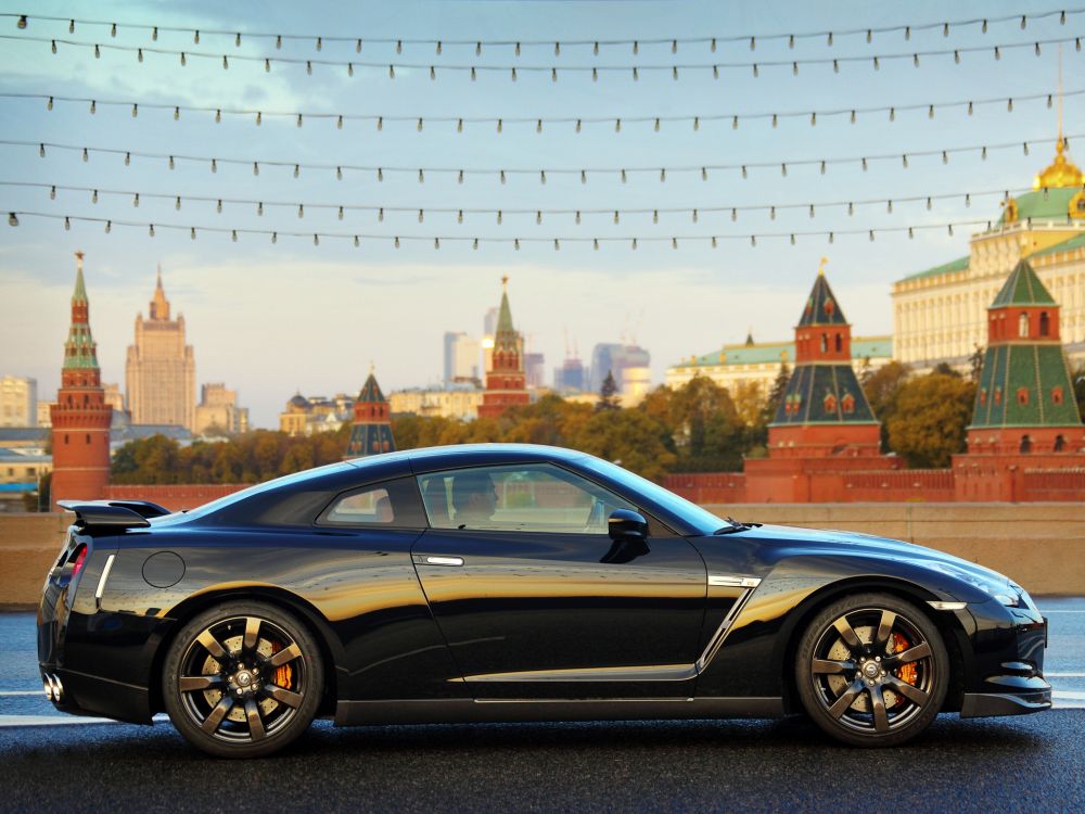 black coupe parked on the side of the road