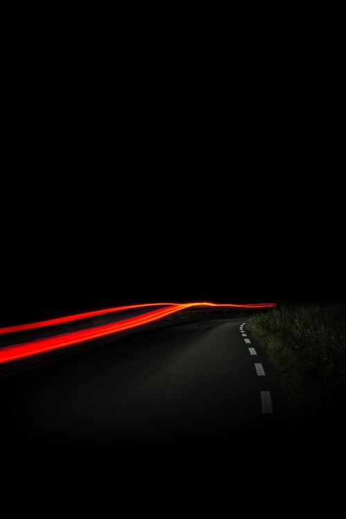 Image red light on black asphalt road