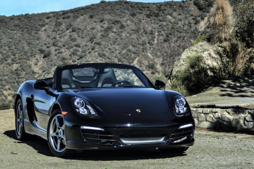 Image black porsche 911 on brown dirt road during daytime