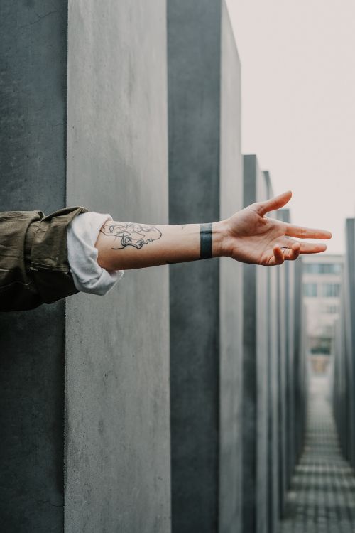 person in brown long sleeve shirt with brown leather strap watch